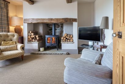 The living room with a log burner at Pen y Bryn, Abersoch