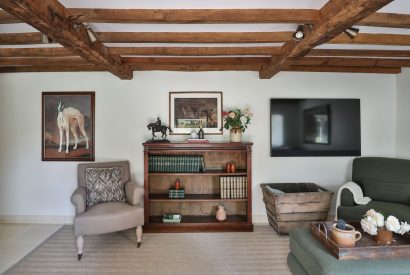 A reading corner in the living room at Rambling Rose Cottage, Cotswolds