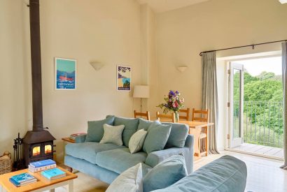 The living room with a log burner at Tigley Cottage, Devon