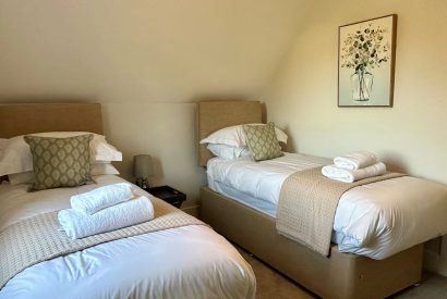 A twin bedroom at Honey Stone Cottage, Cotswolds