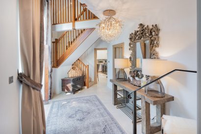 The entrance hall with a view of the staircase at Rose Walls, Lake District 