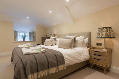 A super king sized bedroom at The Thatched Cottage, Somerset