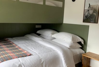 Super king size bed with bunk bed at Stone Mason's Cottage, Roundstone, Galway