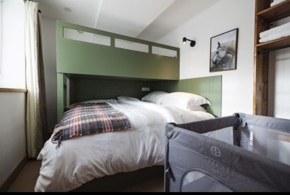 Super king size bed with bunk bed at Stone Mason's Cottage, Roundstone, Galway