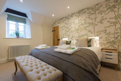 A super king sized bedroom at The Thatched Cottage, Somerset