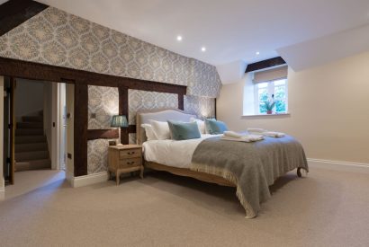 A super king sized bedroom at The Thatched Cottage, Somerset