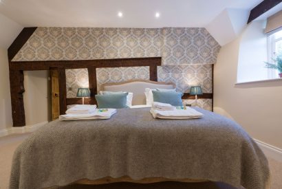 A super king sized bedroom at The Thatched Cottage, Somerset