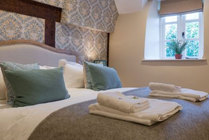 A super king sized bedroom at The Thatched Cottage, Somerset