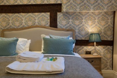 A super king sized bedroom at The Thatched Cottage, Somerset