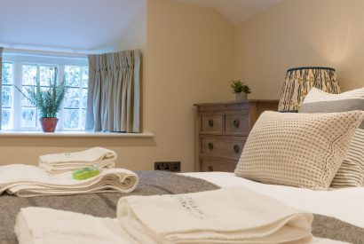 A super king sized bedroom at The Thatched Cottage, Somerset