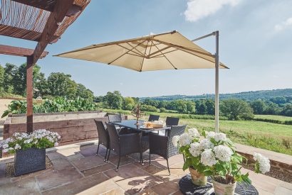 The outdoor dining table and view at Horseshoe House, Peak District