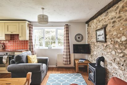 The living room with log burner at Harcombe Cottage, Devon