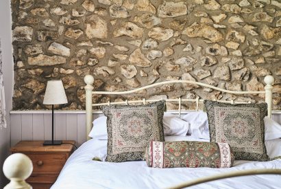 The double bed and side table at Tree Pipit Cottage, Devon