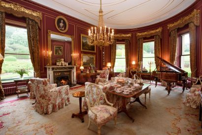 The red drawing room at Broughton Hall, Yorkshire Dales