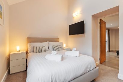A super king size bedroom at Oxwich Retreat, Gower