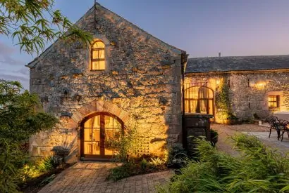 The exterior of the cottage at night at Rose Walls, Lake District