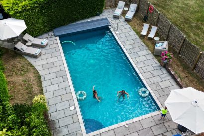 The heated outdoor swimming pool at Lovage Pyggy, Hampshire
