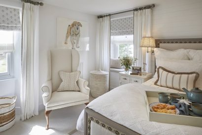 A bedroom with an armchair at The Beach House, Devon