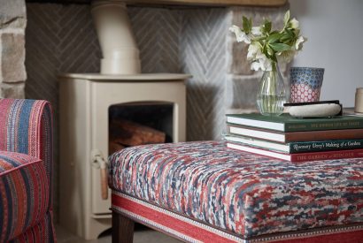 The log burner with foot stool at Beatrix Cottage, Lake District