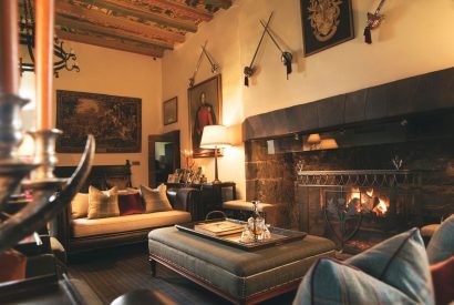 The living room with fireplace at Ogilvie Castle, Cairngorms