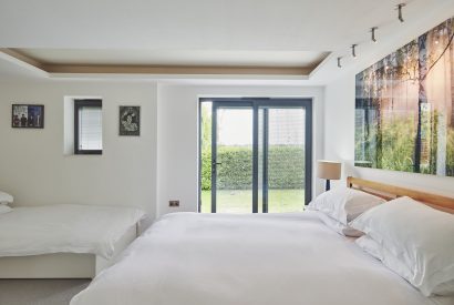 A bedroom with a balcony at The Crewhouse, Hampshire