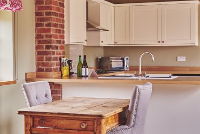 The two-seater dining table and chairs at The Dairy Barn, Worcestershire 