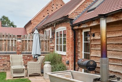 The wood-fired Swedish Hikki hot tub in the private garden at The Dairy Barn, Worcestershire 