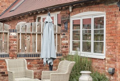 The rattan garden furniture in the private garden at The Dairy Barn, Worcestershire 