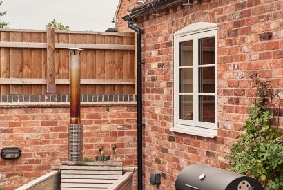 The wood-fired Swedish Hikki hot tub and barbeque in the private garden at Stable Cottage, Worcestershire