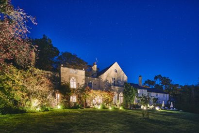 The exterior at night of Roupel Estate, Devon