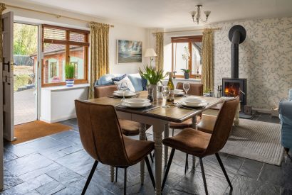 The dining room with log burner at Cuckoo Cottage, Devon