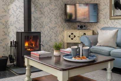 The living room with log burner at Cuckoo Cottage, Devon