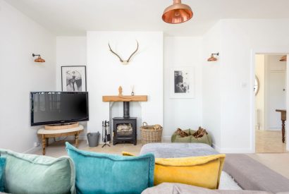 The living room with a log burner at Brickworks and Vines, Isle of Wight