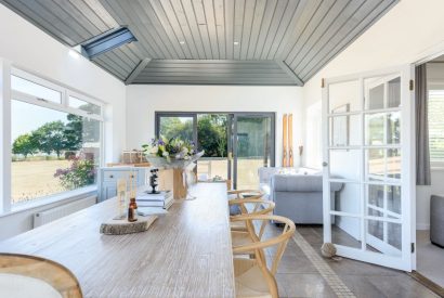 The dining room with doors leading onto the garden at Brickworks and Vines, Isle of Wight