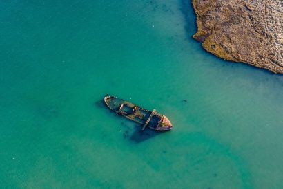 A boat wreck in the sea at Brickworks and Vines, Isle of Wight