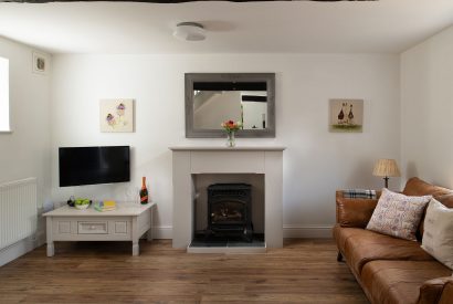 The sofa and TV in the living room at The Milking Parlour, Wiltshire 