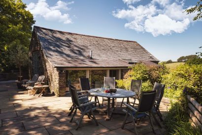 The private patio with an outdoor dining table at Fern House, Devon