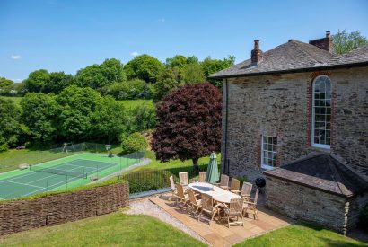 The exterior of Georgian House, Devon overlooking the tennis court