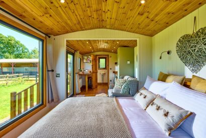 The bed overlooking the countryside view at Abberley Shepherd's Hut, Worcestershire