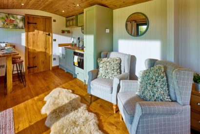 Two armchairs overlooking the countryside view at Abberley Shepherd's Hut, Worcestershire