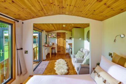 The bedroom overlooking the living space at Abberley Shepherd's Hut, Worcestershire