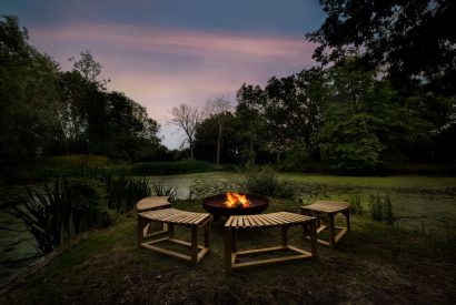 The fire pit at night at Merry Manor, Essex