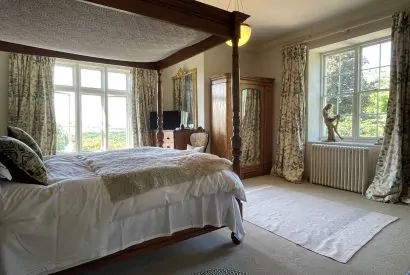 A four poster bedroom at Chulmleigh Manor, Devon