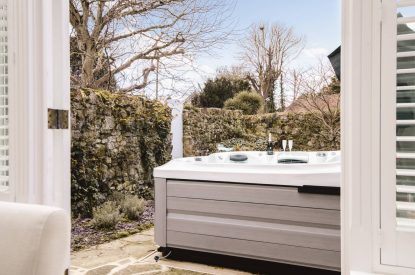 Doors onto the patio and hot tub at Rose Cottage, Isle of Wight