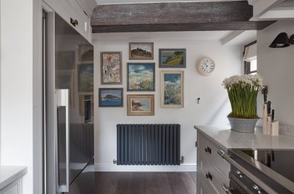 The kitchen with pictures at Beatrix Cottage, Lake District