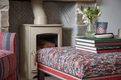 The log burner with foot stool at Beatrix Cottage, Lake District