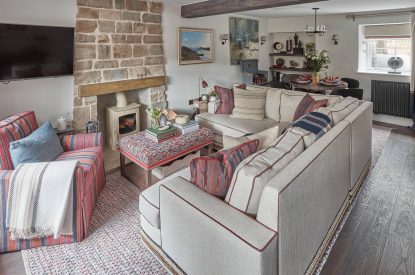 The living and dining room with log burner at Beatrix Cottage, Lake District