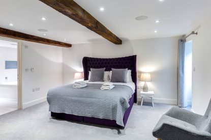 The bedroom with beams at The Shippon Cottage, Lake District