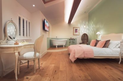 The bedroom with free standing bath at Twitchers Cottage, Lake District