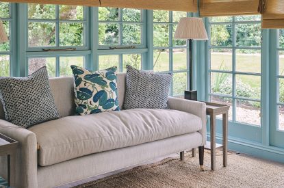 A sofa in the orangery at Bridlepath Cottage, North Wessex Downs